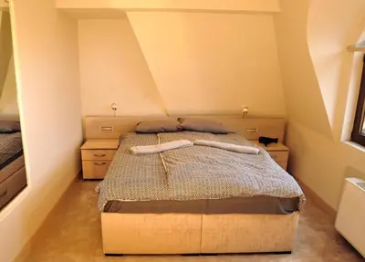 a bedroom with a bed and two night stands at City SMART in Niš