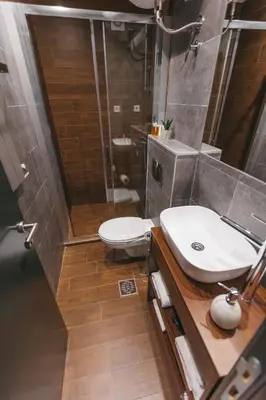 a bathroom with a toilet and a sink and a shower at City Centar House in Niš