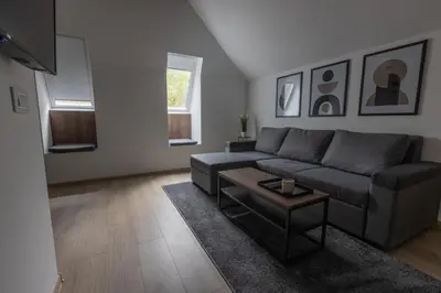 a living room with a couch and a table at City Centar House in Niš
