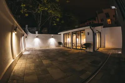 a courtyard at night with lights on a building at City Centar House in Niš