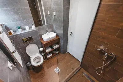 a bathroom with a toilet and a sink at City Centar House in Niš