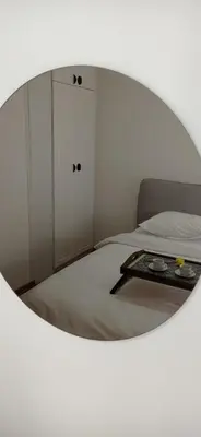a bedroom with a bed with a mirror on it at Visnja Aparmtani in Vrnjačka Banja
