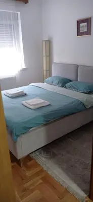 a bed with two towels on it in a bedroom at Visnja Aparmtani in Vrnjačka Banja