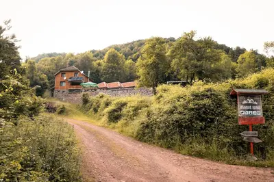 a dirt road with a sign next to a house at Jaćimov Konak in Pirot