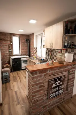 a kitchen with a brick wall and a counter top at Jaćimov Konak in Pirot