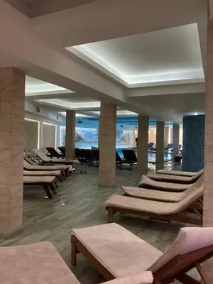 a lobby with lounge chairs and a view of the ocean at Apartman N101, Milmari, Kopaonik in Kopaonik