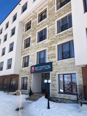 a building with a sign that reads n reception at Apartman N101, Milmari, Kopaonik in Kopaonik