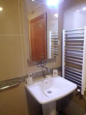 a bathroom with a white sink and a mirror at Nektar 88 in Vrnjačka Banja