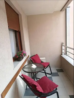 a small balcony with two chairs and a table at Nektar 88 in Vrnjačka Banja