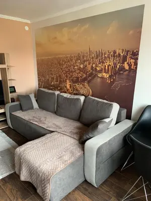 a living room with a couch and a city mural at Aleksinac Centar in Aleksinac