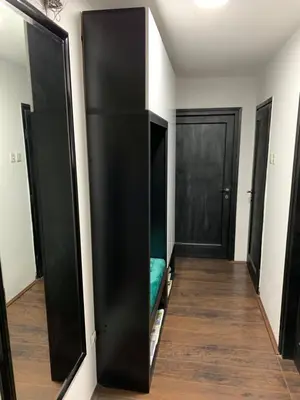 a room with black walls and a closet with a couch at Aleksinac Centar in Aleksinac