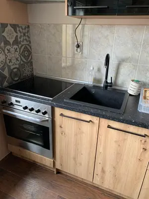a kitchen with a sink and a stove at Aleksinac Centar in Aleksinac