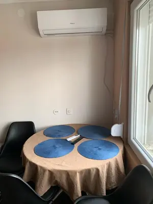a table with four blue plates on it in a room at Aleksinac Centar in Aleksinac