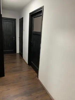 an empty room with two doors and a wooden floor at Aleksinac Centar in Aleksinac