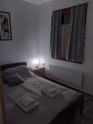 a bedroom with a bed with two towels on it at STD Kuća Talija in Kalna