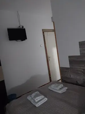 a bedroom with a bed with two towels on it at STD Kuća Talija in Kalna