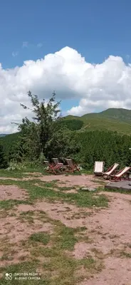 a group of chairs and tables in a field at STD Kuća Talija in Kalna