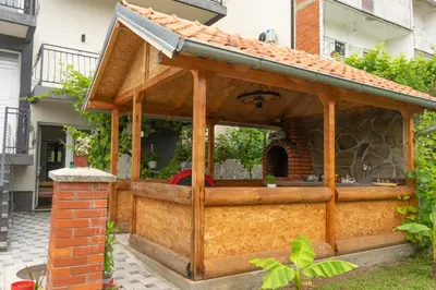 a wooden pavilion with a roof on a house at Sobe Jovan in Soko Banja
