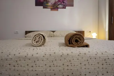 a bed with two towels on top of it at Sobe Jovan in Soko Banja