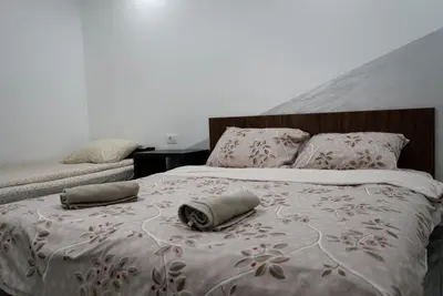 a bed with two pillows on top of it at Sobe Jovan in Soko Banja