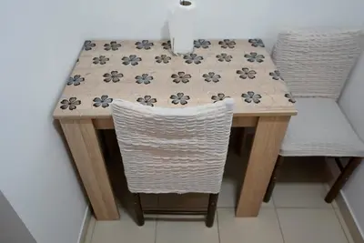 a table with two chairs and a table with a table cloth at Sobe Jovan in Soko Banja