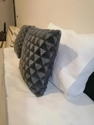 a pillow sitting on top of a bed at HUSKY Milmari in Kopaonik