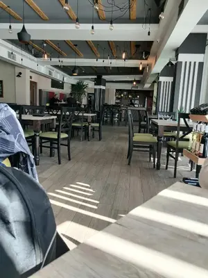 a dining room with tables and chairs and lights at HUSKY Milmari in Kopaonik