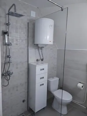 a bathroom with a toilet and a glass shower at Vila Gala in Kopaonik