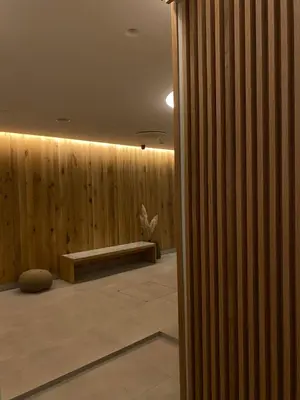 a room with a wooden wall with a bench at Pegaz009**** in Vrnjačka Banja