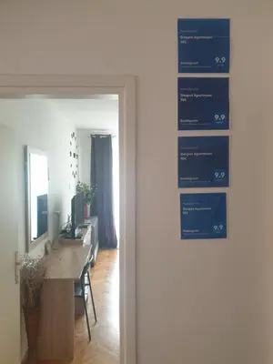 a sign on the door of a room with a desk at Despot Apartmani Niš in Niš