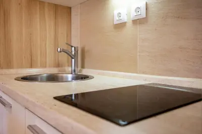 a kitchen with a sink in a counter top at kopaonik konaci centar lux apartman in Kopaonik