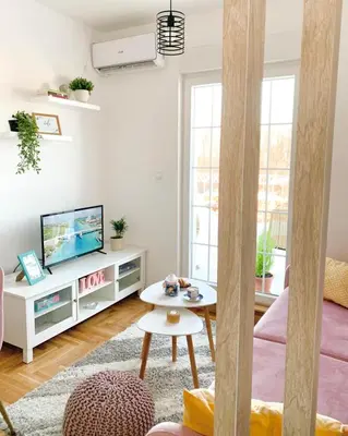 a living room with a tv and a table at Apartment Atria II in Vrnjačka Banja