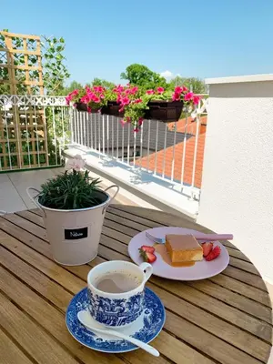 a cup of coffee and a plate of cake on a table at Apartment Atria II in Vrnjačka Banja