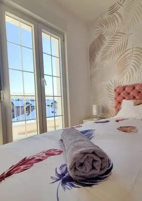 a bedroom with a bed with a towel on it at Apartment Atria II in Vrnjačka Banja