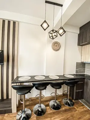 a kitchen with a black table and stools at President Kop A410 in Kopaonik