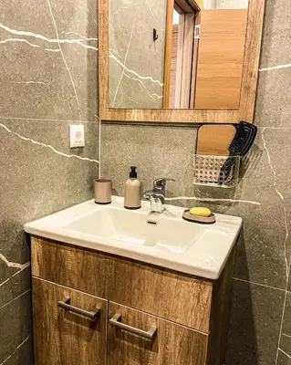 a bathroom with a sink and a mirror at President Kop A410 in Kopaonik