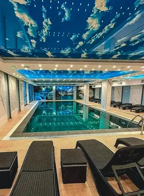 a large swimming pool with a mural of a sky at President Kop A410 in Kopaonik