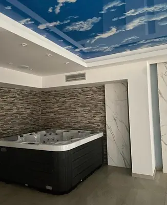 a room with a bath tub with a blue ceiling at President Kop A410 in Kopaonik