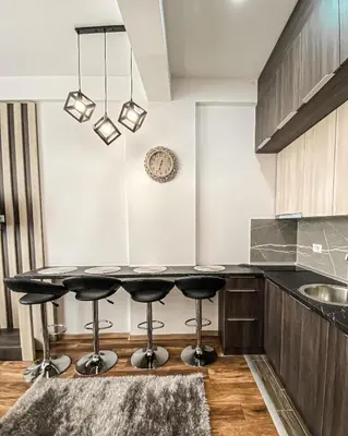 a kitchen with a table and stools at President Kop A410 in Kopaonik