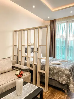 a living room with a bed and a couch at President Kop A410 in Kopaonik
