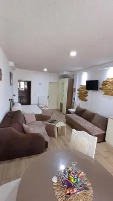a living room with a couch and a table at Apartman ''Nena,, in Soko Banja