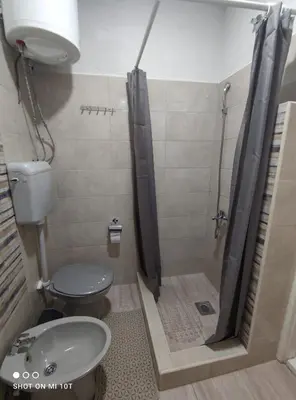 a bathroom with a shower with a toilet and a sink at Apartman ''Nena,, in Soko Banja