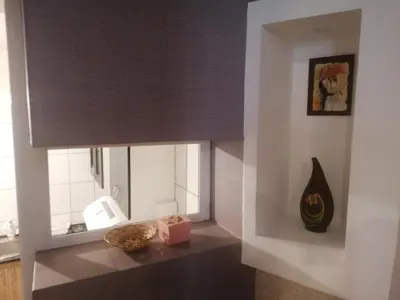 a room with a window with a table and a mirror at Apartman Centar 2 in Kruševac