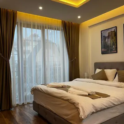 a bedroom with two beds and a large window at President Kop - Silver Ice Apartment in Kopaonik