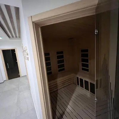 a glass door into a room with a walk in closet at President Kop - Silver Ice Apartment in Kopaonik