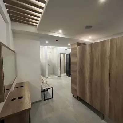 a room with a table and a wooden partition at President Kop - Silver Ice Apartment in Kopaonik