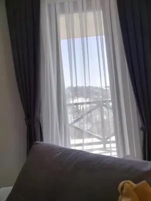 a bedroom with a window with a view of a deck at Apartman Milly in Kopaonik