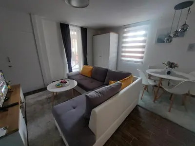 a living room with a couch and a table at Apartman Milly in Kopaonik