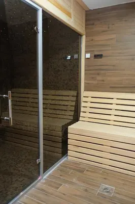 a sauna with benches in a room with wooden walls at Drvena Kuca RUŽA in Kopaonik