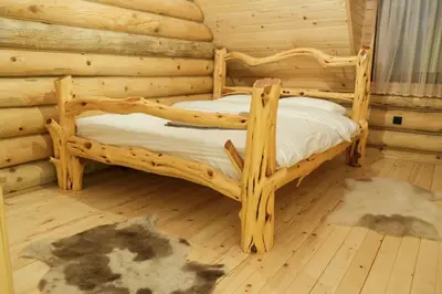 a bedroom with two bunk beds in a log cabin at Drvena Kuca RUŽA in Kopaonik